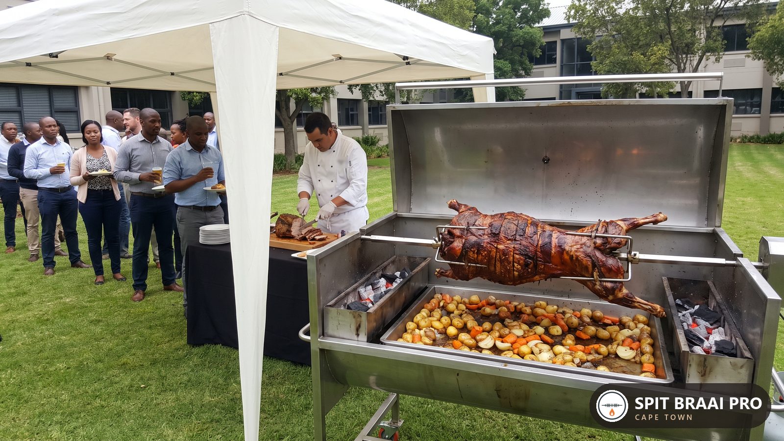 Corporate function on a lawn with a catering carving station under a gazebo